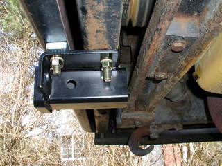 a catch bolted to the bumper and boot of the school bus